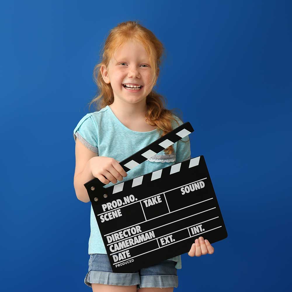 A child holding a clapper board.