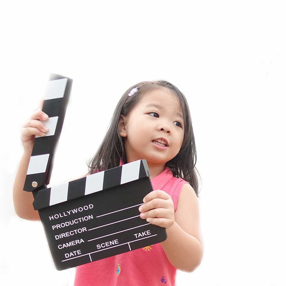 A child holding a clapper board.